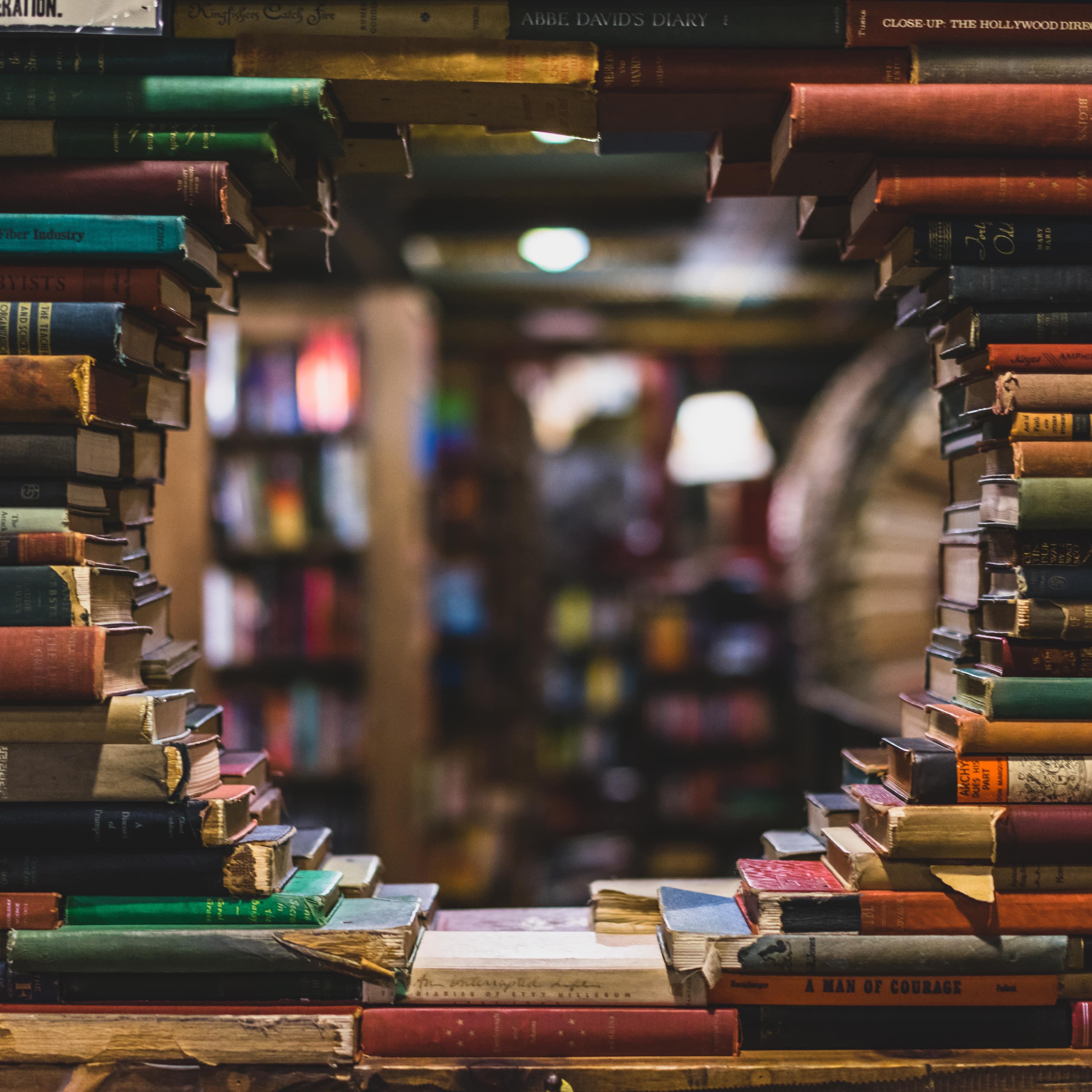 Background image with stacks of books and hole in a middle